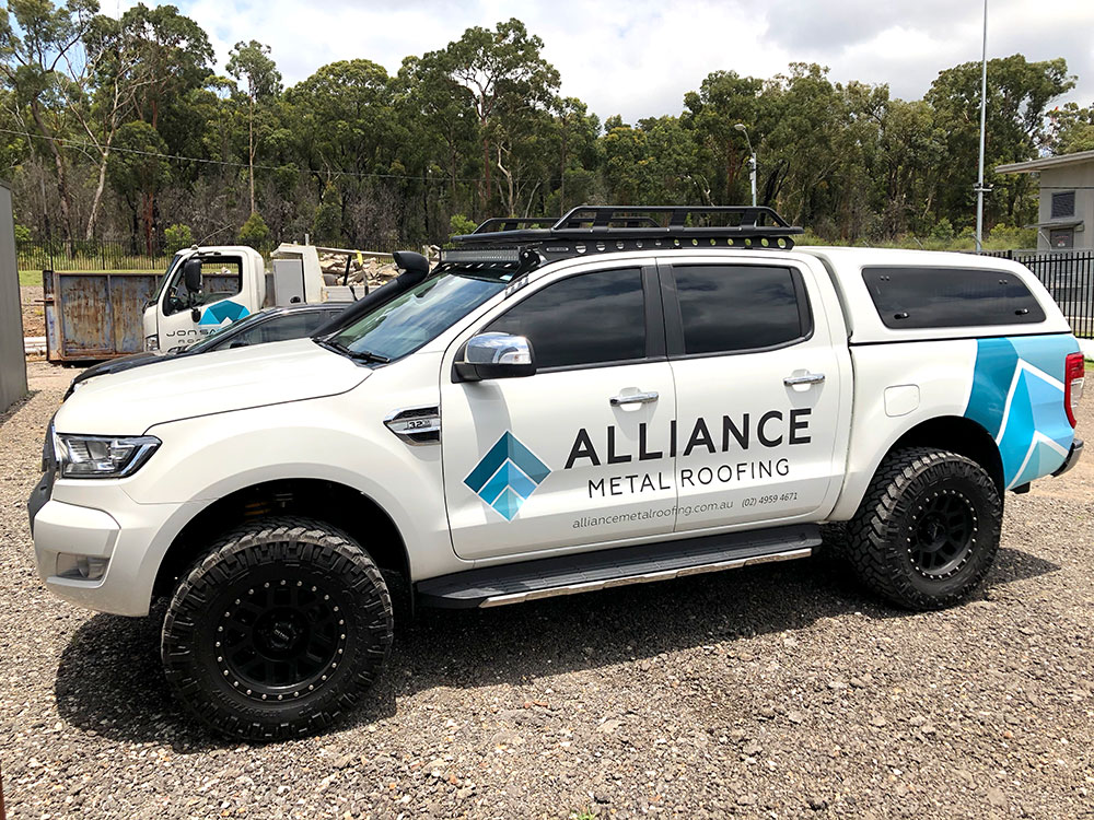White Ford Ranger with canopy owned by Alliance Metal Roofing
